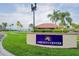 The Amenity Center sign on a stucco wall with green grass and palm trees at 1512 3Rd Street E Cir, Palmetto, FL 34221