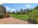 Beautiful backyard view with lush green space and colorful flower bushes at 1512 3Rd Street E Cir, Palmetto, FL 34221
