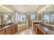 Beautiful bathroom featuring double vanities, a soaking tub, and a separate shower with tiled walls at 1512 3Rd Street E Cir, Palmetto, FL 34221