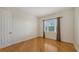 A minimalist bedroom features hardwood floors and a window, perfect for relaxation and rest at 1512 3Rd Street E Cir, Palmetto, FL 34221