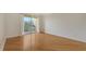 Bright bedroom with hardwood floors and sliding glass doors to a private balcony overlooking a green space at 1512 3Rd Street E Cir, Palmetto, FL 34221
