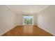 Bright bedroom features hardwood floors and a balcony, inviting relaxation and contemplation of the outdoors at 1512 3Rd Street E Cir, Palmetto, FL 34221