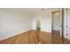 Spacious bedroom with hardwood flooring, white walls, and doorways leading to other parts of the home at 1512 3Rd Street E Cir, Palmetto, FL 34221