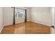 A minimalist bedroom has sleek hardwood floors and a bright window, perfect for relaxation and rest at 1512 3Rd Street E Cir, Palmetto, FL 34221