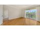 Bright bedroom features hardwood floors and a balcony, perfect for enjoying the green outdoor scenery at 1512 3Rd Street E Cir, Palmetto, FL 34221
