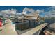 Covered boat on a lift in a marina with boats, docks, and cloudy blue skies at 1512 3Rd Street E Cir, Palmetto, FL 34221