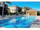 Community pool with plenty of seating, poolside structure, and close proximity to residential condos at 1512 3Rd Street E Cir, Palmetto, FL 34221
