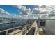 Long dock on the water with boats docked and cloudy blue skies above at 1512 3Rd Street E Cir, Palmetto, FL 34221