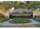Riviera Dunes Resort & Yacht Club entrance sign with decorative flowers and palm trees at 1512 3Rd Street E Cir, Palmetto, FL 34221