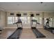 Treadmills and an elliptical overlooking the pool in the community gym at 1512 3Rd Street E Cir, Palmetto, FL 34221