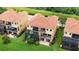 Exterior aerial view of home, with screened in lanai, and lush landscaping at 1512 3Rd Street E Cir, Palmetto, FL 34221