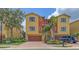 Attractive two-story townhouse featuring a brick paved driveway, garage, and vibrant landscaping at 1512 3Rd Street E Cir, Palmetto, FL 34221