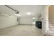 Spacious garage with epoxy flooring, bright lighting, and storage shelving at 1512 3Rd Street E Cir, Palmetto, FL 34221