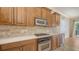 Charming kitchen featuring stainless steel appliances, wooden cabinetry, and elegant quartz countertops at 1512 3Rd Street E Cir, Palmetto, FL 34221