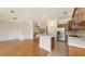 Open-concept kitchen with an island, stainless steel appliances, and hardwood flooring at 1512 3Rd Street E Cir, Palmetto, FL 34221