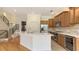 Well-lit kitchen with a quartz island, stainless steel appliances, and hardwood floors at 1512 3Rd Street E Cir, Palmetto, FL 34221