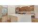 Bright kitchen showcasing wooden cabinets, stainless steel appliances, and a convenient center island at 1512 3Rd Street E Cir, Palmetto, FL 34221
