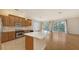 Spacious kitchen featuring stainless steel appliances, an island, and hardwood floors at 1512 3Rd Street E Cir, Palmetto, FL 34221