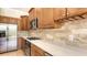 Close-up of kitchen boasting wooden cabinets, stainless steel appliances, and quartz countertops at 1512 3Rd Street E Cir, Palmetto, FL 34221