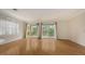 Open living space with hardwood floors, balcony, and bright natural light at 1512 3Rd Street E Cir, Palmetto, FL 34221