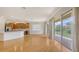 Hardwood flooring flows through an open layout with a kitchen and balcony access at 1512 3Rd Street E Cir, Palmetto, FL 34221