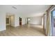 Bright living room with wood floors, sliding glass doors and access to a bathroom and garage at 1512 3Rd Street E Cir, Palmetto, FL 34221