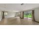 Spacious living room featuring wood-look flooring and sliding glass doors leading to an outdoor view at 1512 3Rd Street E Cir, Palmetto, FL 34221
