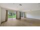 Open living area with wood flooring, large sliding doors, and view to the exterior at 1512 3Rd Street E Cir, Palmetto, FL 34221