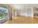 Spacious living room with hardwood floors, balcony access, and stairway at 1512 3Rd Street E Cir, Palmetto, FL 34221