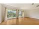 Open living room with wood floors and large sliding doors to the balcony at 1512 3Rd Street E Cir, Palmetto, FL 34221