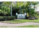 The Hammocks at Riviera Dunes community sign with lush landscaping, greenery, and a brick walkway at 1512 3Rd Street E Cir, Palmetto, FL 34221