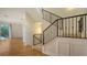 A staircase has a wrought iron railing and wooden flooring, blending elegance with structural appeal at 1512 3Rd Street E Cir, Palmetto, FL 34221
