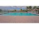 Inviting community swimming pool surrounded by paved deck and palm trees, ideal for relaxation at 1512 3Rd Street E Cir, Palmetto, FL 34221
