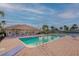 Outdoor swimming pool with lounge chairs and shade perfect for relaxing under the palms at 1512 3Rd Street E Cir, Palmetto, FL 34221