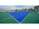 Aerial view of a professionally maintained tennis court by the water, perfect for recreational play at 1512 3Rd Street E Cir, Palmetto, FL 34221