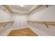 Spacious walk-in closet with wood shelves and bamboo floors, providing ample storage space at 1512 3Rd Street E Cir, Palmetto, FL 34221