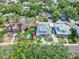 Stunning aerial view of a home featuring a pool, putting green, and beautifully landscaped grounds surrounded by lush greenery at 1523 1St W Ave, Bradenton, FL 34205