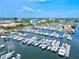Picturesque aerial view of a marina filled with boats and yachts surrounded by lush greenery and buildings at 1523 1St W Ave, Bradenton, FL 34205