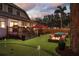 Delight in the backyard, complete with a putting green, hot tub, fire pit, and deck, ideal for relaxing and entertaining guests at 1523 1St W Ave, Bradenton, FL 34205
