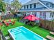 Experience the backyard oasis featuring a putting green, spa, fire pit area, and a well-maintained deck perfect for outdoor living at 1523 1St W Ave, Bradenton, FL 34205