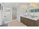 Bright bathroom featuring double vanity, glass-enclosed shower, and separate toilet area for added convenience at 1523 1St W Ave, Bradenton, FL 34205