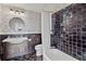 Stylish bathroom featuring custom tile work, vanity, round mirror, and combination shower/tub at 1523 1St W Ave, Bradenton, FL 34205