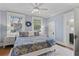 Serene bedroom with light blue walls, white trim, a queen bed, and a view of the garden at 1523 1St W Ave, Bradenton, FL 34205