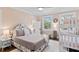 Comfortable bedroom with a queen-sized bed, floral headboard, and decorative pillows at 1523 1St W Ave, Bradenton, FL 34205