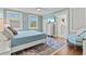 Cozy bedroom featuring a ceiling fan, a decorative rug, and an en-suite walk-in closet at 1523 1St W Ave, Bradenton, FL 34205