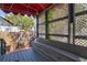Relaxing covered porch featuring lattice accents, seating, and string lights, perfect for outdoor enjoyment at 1523 1St W Ave, Bradenton, FL 34205