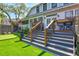 Backyard deck with stairs, artificial turf, and barbecue grill, perfect for outdoor entertaining at 1523 1St W Ave, Bradenton, FL 34205
