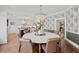 Elegant dining room with a large chandelier and beautiful wallpaper at 1523 1St W Ave, Bradenton, FL 34205