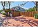 Charming home exterior with a bamboo fence, brick paved area, and lush greenery, offering privacy at 1523 1St W Ave, Bradenton, FL 34205