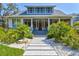 Charming two-story home with landscaped yard and inviting front porch at 1523 1St W Ave, Bradenton, FL 34205